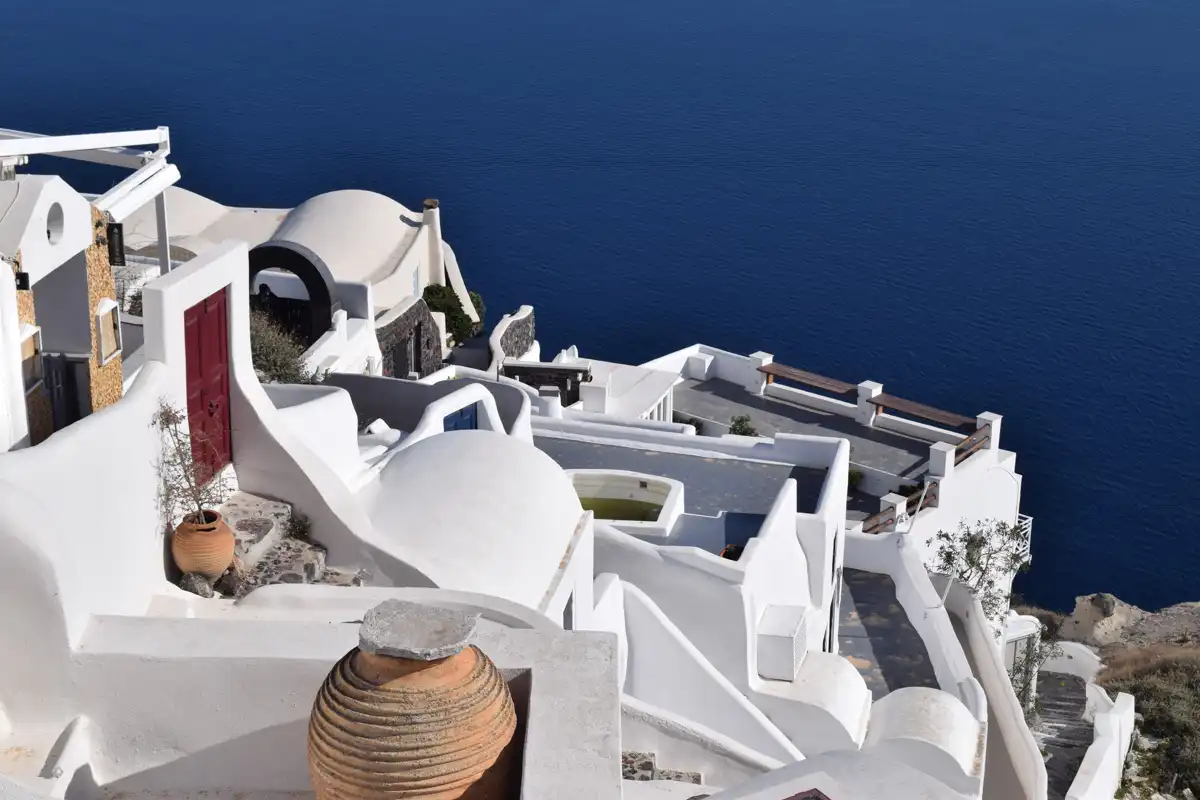 house terraces in santorini on the edge of a seaside cliff