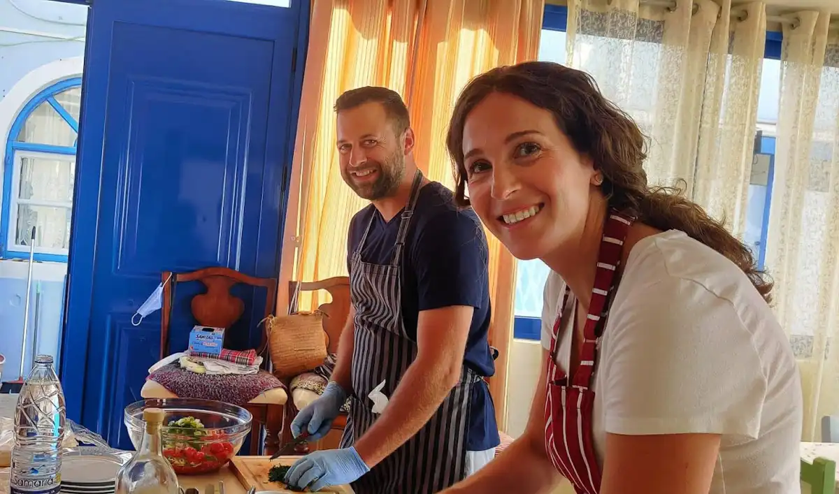 Santorini's local chefs, a woman and a man they are cooking, in a traditional tavern
