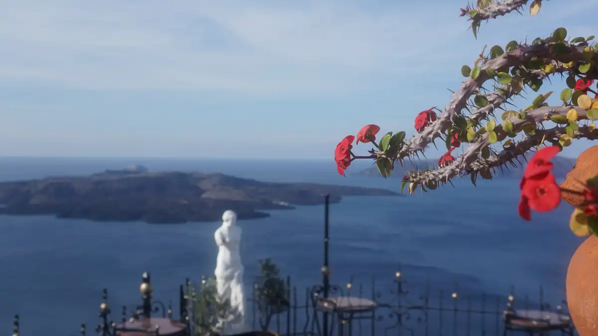sea view from the garden of a house in santorini, and an ancient greek style statue
