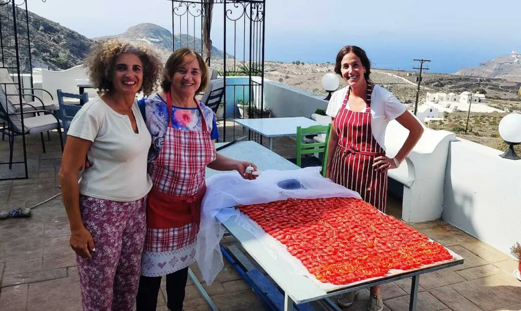 three women make traditional dishes in santorini