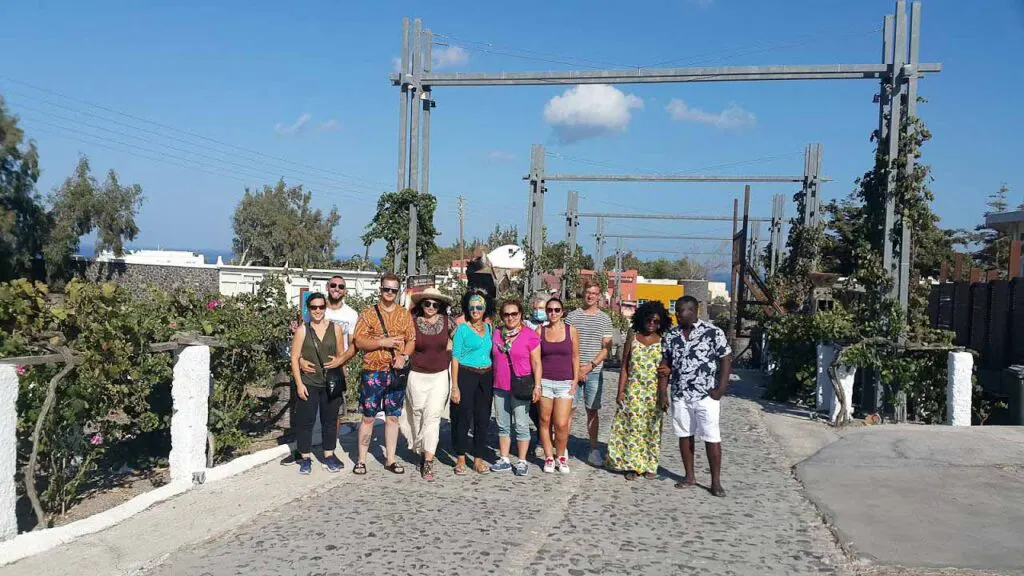 group of tourists in a vineyard in santorini