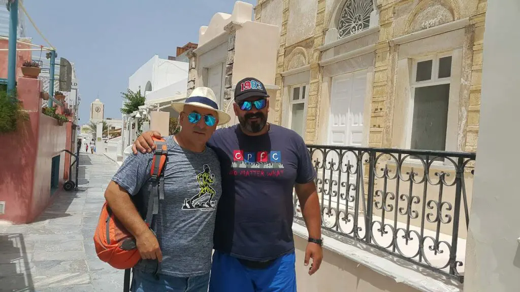 two men in an alley of the city of Santorini