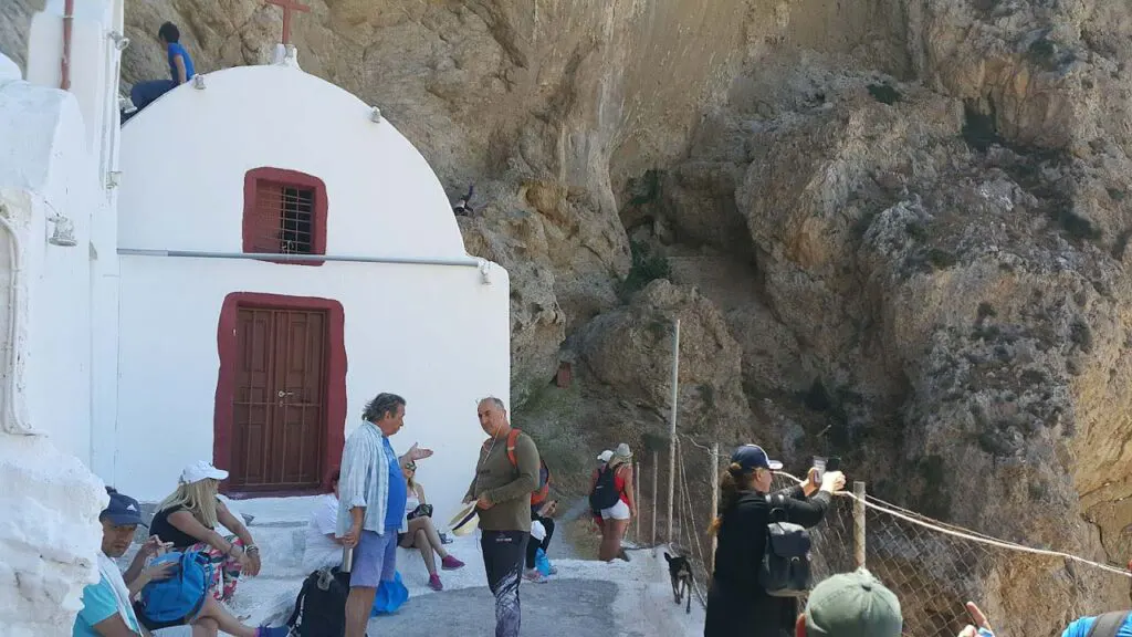 tourists in the courtyard of a traditional church in Santorini